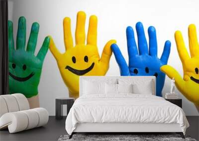 Six colorful hands with smiley faces painted on them, raised up in the air. Wall mural