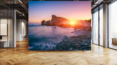 Aphrodite's Rock beach, Petra tou Romiou, the birthplace of Goddness Aphrodite, Paphos, Cyprus. Amazing sunset seascape of Love beach with rocks and sea pebbles, travel background, tourist location Wall mural