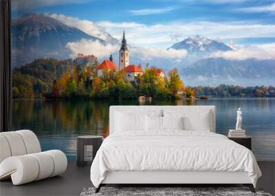 Famous alpine Bled lake (Blejsko jezero) in Slovenia, amazing autumn landscape. Scenic view of the lake, island with church, Bled castle, mountains and blue sky with clouds, outdoor travel background Wall mural