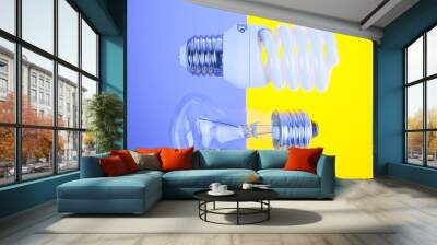 two types of light bulbs on yellow and blue background Wall mural