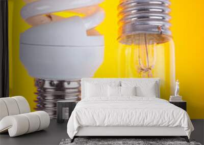 two types of light bulbs on yellow background Wall mural