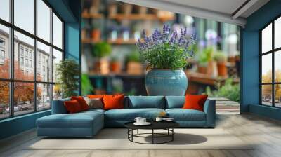 A beautifully composed image capturing a potted lavender plant with vibrant purple blooms in a rustic blue ceramic pot on a wooden table in a plant-filled room Wall mural