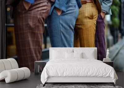 A close-up of three trendy men's lower bodies showcasing diverse patterned trousers for fashion variety Wall mural