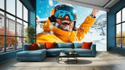 A delighted man in a bright orange jacket and ski goggles celebrates in the snowy outdoors, basking in the joy of skiing and winter sports on a vibrant sunny day. Wall mural