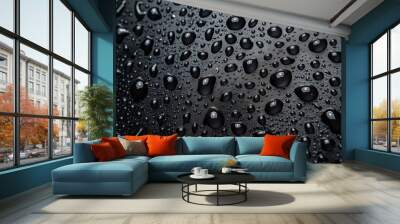 A macro photograph that captures the intricate beauty of water droplets scattered across a dark, sleek surface in varying sizes Wall mural