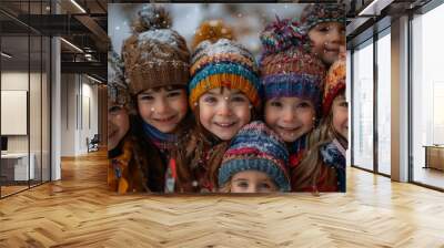 Seven joyful children with snowflakes on their winter hats smiling in a snowy setting Wall mural