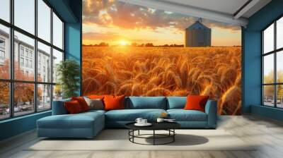 Warm sunset light bathing a wheat field with a distant grain silo creating a tranquil rural scene Wall mural