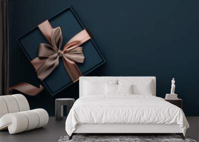 Elegant gift box with a satin ribbon on a dark background. Wall mural