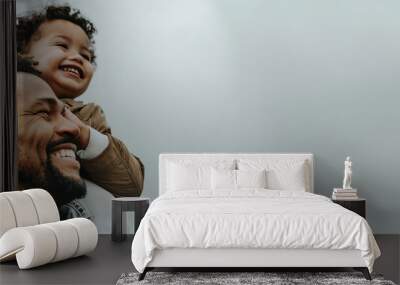 Joyful father with his happy child against a clear sky. Wall mural