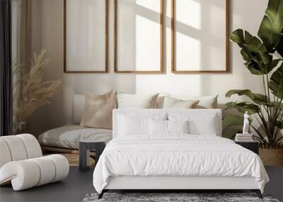 Three empty mockup frames on a wall above a modern sofa with cushions in a bright interior. 2x3 Ratio frame. Wall mural