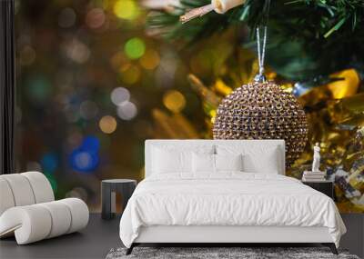 Christmas and new year decorations and illumination with large golden ball in the foreground. Wall mural