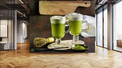 Matcha latte with cream foam in glasses, bamboo whisk tusaku and matcha powder. Wall mural