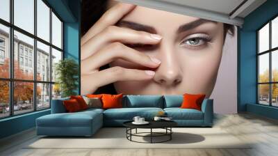 portrait of a brunette woman touching her face with her hand giving the feeling of skin care, ai generative Wall mural