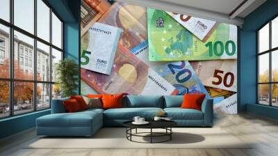 Many european euro money bills in chaotic arrangement. Pile of eur banknotes with different colors and condition Wall mural