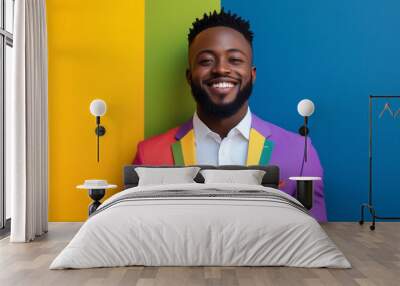  man in a rainbow suit is smiling and posing for a photo. The colorful suit and the bright background create a cheerful and vibrant atmosphere Wall mural