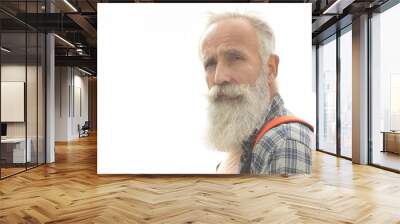 Active senior man walking in the city. Portrait of senior man with a beard while standing outside. Wall mural