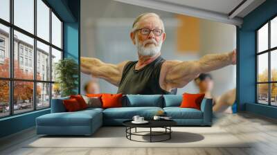 man in a black tank top is doing a yoga pose. He is wearing glasses and has a beard Wall mural