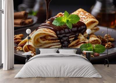 An exquisite culinary photo showing pancakes beautifully decorated with chocolate sauce, nuts and a hint of mint, emphasizing sophistication. Wall mural