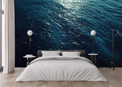 Aerial perspective showcasing dark blue ocean textures and light reflections. Wall mural