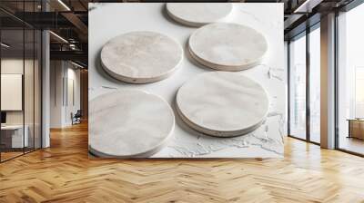 Artificial stone coasters on tabletop. White showcase with copy space. Overhead view. Wall mural