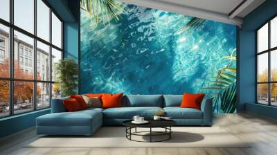 Blue water texture background illuminated by the midday sun, with tropical foliage casting shadows. Wall mural