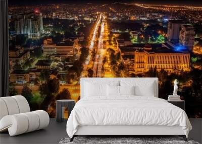 Chisinau, Moldovas capital, seen from above at night. a street lined with autos and plants that leads to the Chisinau gates Wall mural