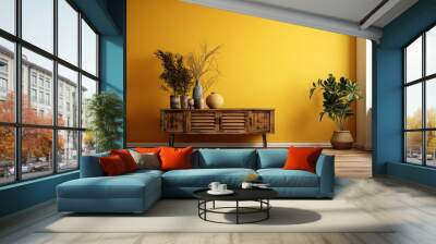 Interior design of an empty room with a wooden table top, cabinet, panel, or shelf that has shutters. dried plants in vases. Parquet flooring and a copy space on a yellow plaster wall. background desi Wall mural