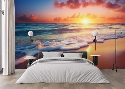 Sunset over the ocean with waves washing onto the beach Wall mural