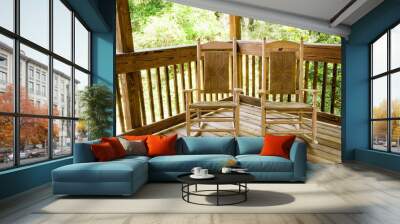 Two Empty Wooden Rocking Chairs on a Front Porch Wall mural