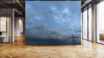 Grey blue sky and an electrical transmission power pylon.  Wall mural