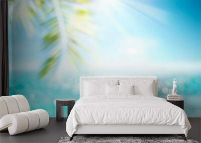 Abstract blur defocused background, toned gently blue, nature of tropical summer, rays of sun light. Beautiful sun glare on sea water and palm leaves against sky. Copy space, summer vacation concept. Wall mural