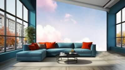 Beautiful background image of a romantic blue sky with soft fluffy pink clouds. Panoramic natural view of a dreamy sky. Wall mural