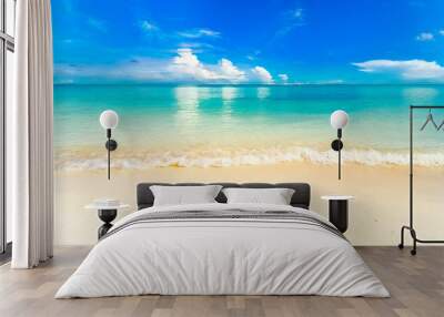 Beautiful background image of tropical beach. Light surf wave with white foam. Blue summer sky, white clouds reflected in turquoise clear water ocean. Relaxation and rest. Wall mural