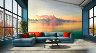 Beautiful cloud over ocean water at sunset in Golden pink blue and green tones. Colorful natural landscape, copy space. Wall mural