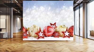 Beautiful colorful Christmas composition of red and gold Christmas balls and stars with copy space on a sparkling light background. Wall mural