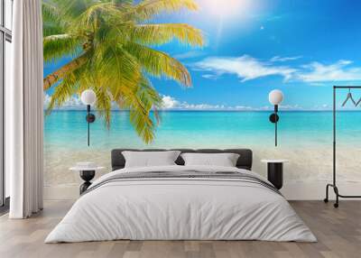 Beautiful natural tropical landscape, beach with white sand and Palm tree leaned over calm wave. Turquoise ocean on background blue sky with clouds on sunny summer day, island Maldives. Wall mural