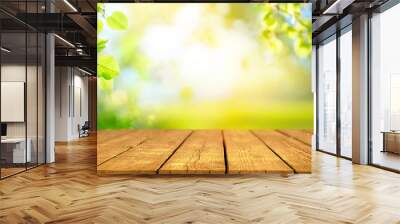 Beautiful spring background with green juicy young foliage and empty wooden table in nature outdoor. Natural template with Beauty bokeh and sunlight. Wall mural