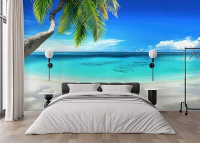 Beautiful tropical beach with white sand, turquoise ocean on  background blue sky with clouds on sunny summer day. Palm tree leaned over water. Perfect landscape for relaxing vacation, island of Maldi Wall mural