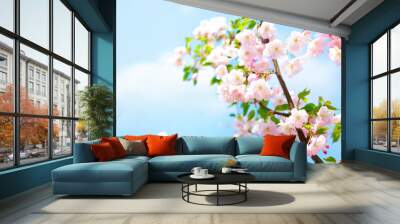 Blossoming cherry on background blue sky and white clouds in spring on nature outdoors. Pink sakura flowers, amazing colorful dreamy romantic artistic image spring nature, banner format, copy space. Wall mural