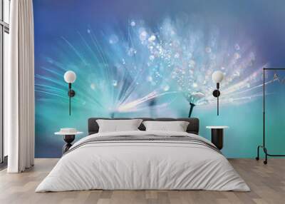 Dandelion Seeds in the drops of dew on a beautiful blurred background. Dandelions on a beautiful blue background. Drops of dew sparkle on the dandelion. Wall mural