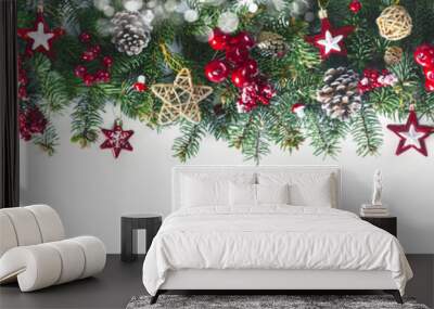 Festive Christmas border, isolated on white background. Fir green branches are decorated with gold stars, fir cones and red berries, close-up. Wall mural