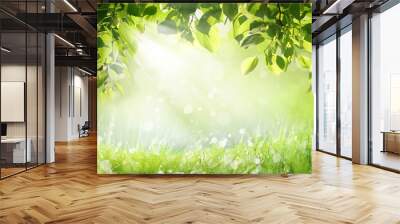 Natural summer spring landscape frame with wet green grass with morning dew and fresh juicy foliage on Sunny day. Ray of sunlight breaks through foliage of trees in Park in nature outdoors. Wall mural