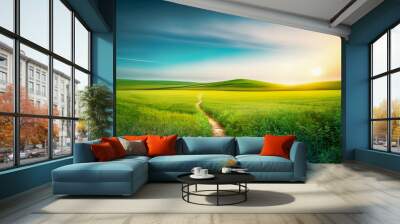 Picturesque winding path through a green grass field in hilly area in morning at dawn against blue sky with clouds. Natural panoramic spring summer landscape. Wall mural