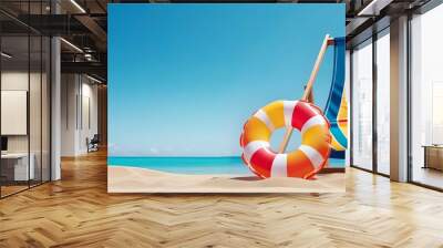 Summer beach holiday concept. A chair and an inflatable swimming ring on sand of beach against the backdrop of the sea and blue sky. Wall mural