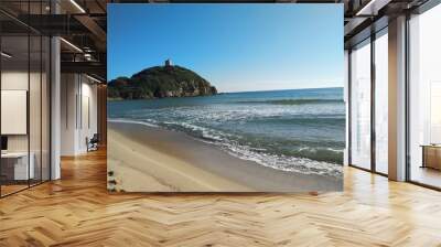 Mediterranean seascape of sandy beach, turquoise water and old Chia tower on the hill Wall mural