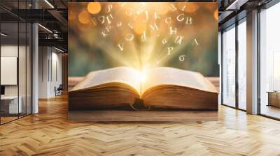 imagine opening an old book blurred with magic power on the table and the english alphabet floating above the book with magic light as a beautiful background design Wall mural