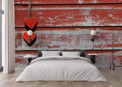 Two rustic antique red wooden hearts hanging by rope on old painted barn; blank holiday sign with copy space Wall mural