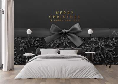 Christmas background with shining black snowflakes and a black ribbon with bow. Wall mural