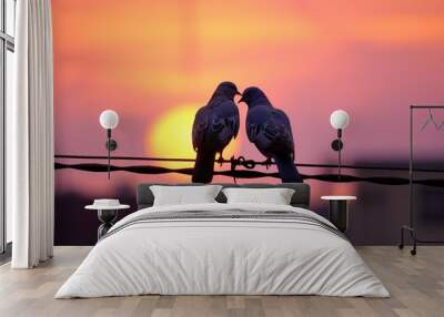 Two pigeons on a wire, silhouette in the sunset, love birds, in the style of humor meets heart, backlight Wall mural