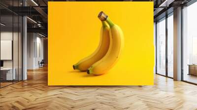 Yellow banana on yellow background | ripe banana fruit on yellow studio backdrop Wall mural